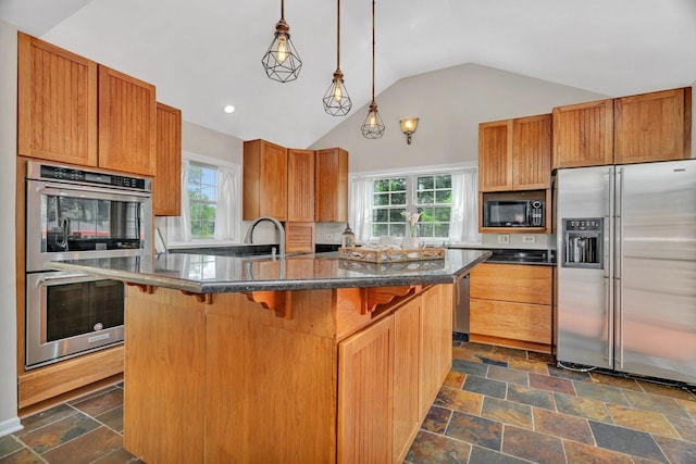 336 Brooklea Ct, Naperville, IL 60565 - kitchen featuring appliances with stainless steel finishes, vaulted ceiling, healthy amount of natural light, a kitchen breakfast bar, and stone tile flooring