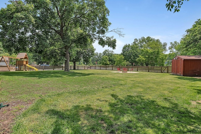 336 Brooklea Ct, Naperville, IL 60565 - fenced backyard with a playground, a storage unit, and view of wooded area