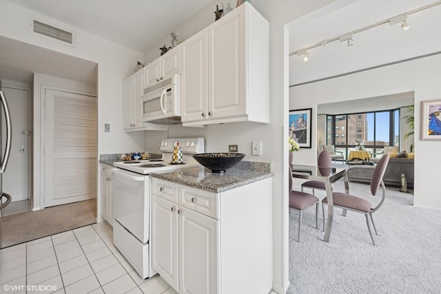 1530 N Dearborn Pkwy Unit 9S, Chicago, IL 60610 - kitchen featuring white appliances, light colored carpet, white cabinets, stone countertops, and track lighting