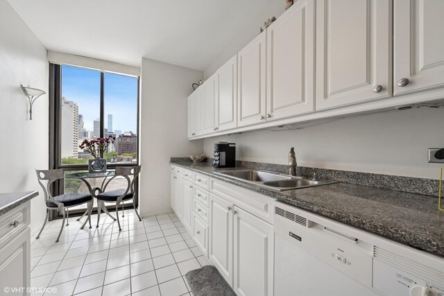 1530 N Dearborn Pkwy Unit 9S, Chicago, IL 60610 - kitchen featuring dishwasher, white cabinets, a view of skyline, and light tile patterned floors