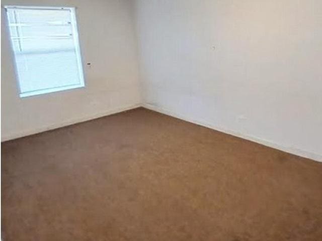 3254 W Flournoy St Unit 1, Chicago, IL 60624 - carpeted empty room featuring baseboards