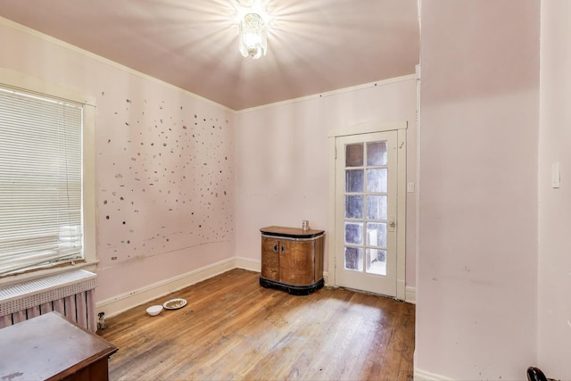 5042 W Wolfram St, Chicago, IL 60641 - spare room featuring radiator heating unit, wood finished floors, and crown molding