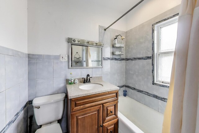 5042 W Wolfram St, Chicago, IL 60641 - bathroom featuring vanity, plenty of natural light, and tile walls
