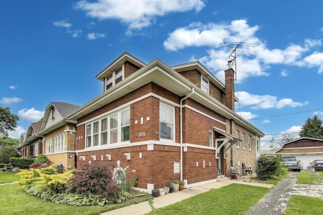 5042 W Wolfram St, Chicago, IL 60641 - view of property exterior featuring brick siding, a lawn, a chimney, and entry steps