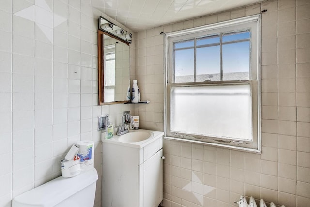 5042 W Wolfram St, Chicago, IL 60641 - half bathroom featuring tile walls, vanity, and backsplash