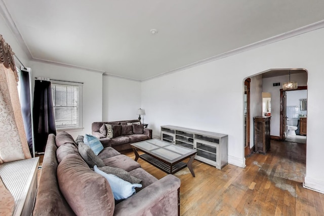 5042 W Wolfram St, Chicago, IL 60641 - living room featuring arched walkways, wood-type flooring, and ornamental molding