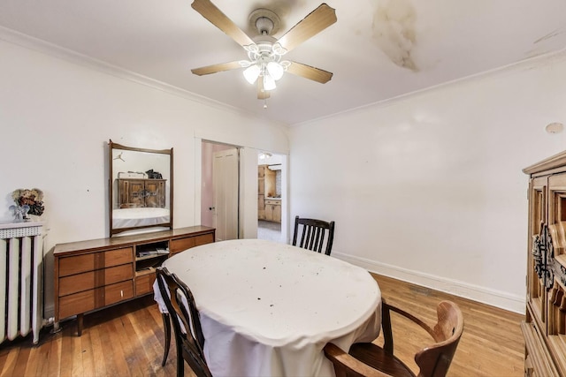 5042 W Wolfram St, Chicago, IL 60641 - dining area featuring ceiling fan, ornamental molding, radiator heating unit, and hardwood / wood-style flooring