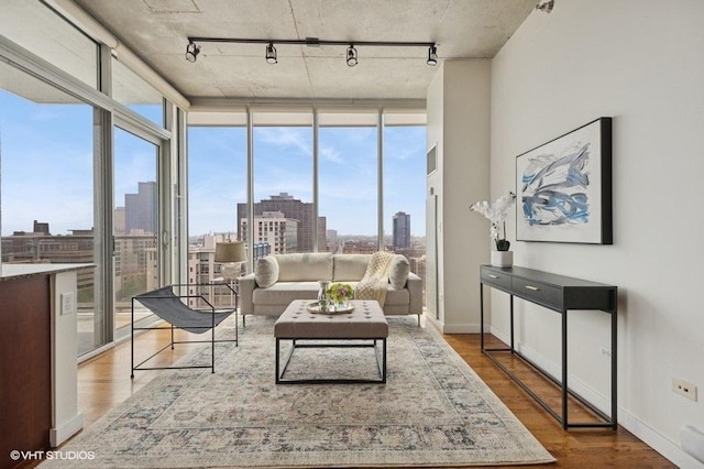 1720 S Michigan Ave Unit 1608, Chicago, IL 60616 - living room with rail lighting, floor to ceiling windows, wood finished floors, a view of skyline, and baseboards