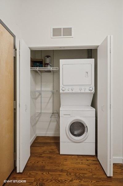 1720 S Michigan Ave Unit 1608, Chicago, IL 60616 - laundry room featuring stacked washer / dryer and dark wood finished floors