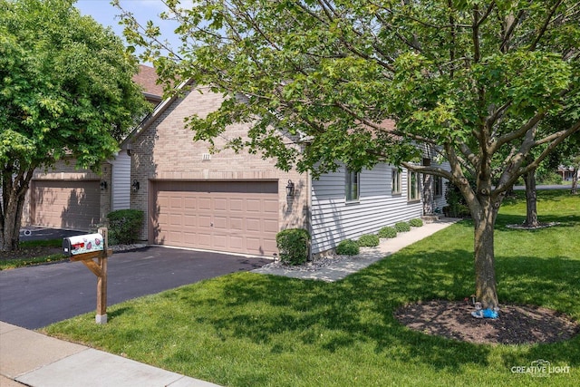 111 Fawn Ln, Elgin, IL 60120 - obstructed view of property featuring driveway, a front lawn, and a garage
