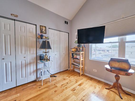 4813 W 23rd St, Cicero, IL 60804 - bedroom with two closets, wood finished floors, and high vaulted ceiling