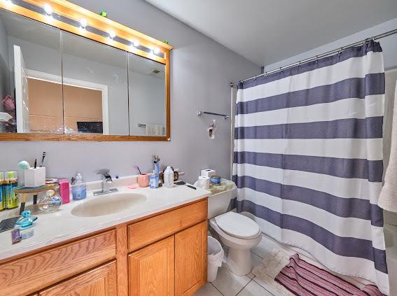 4813 W 23rd St, Cicero, IL 60804 - full bathroom featuring vanity, a shower with curtain, and tile patterned flooring