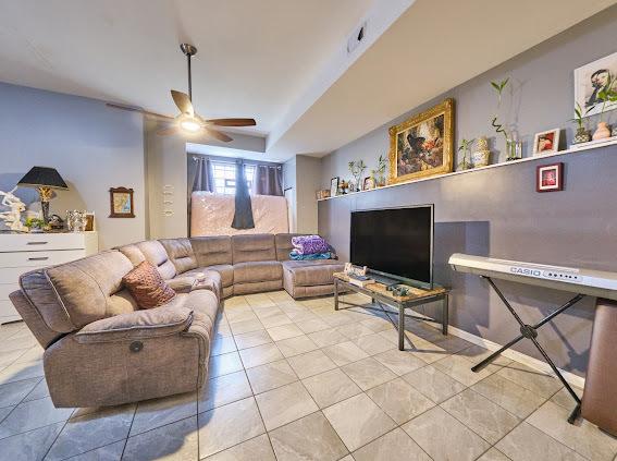 4813 W 23rd St, Cicero, IL 60804 - living area featuring ceiling fan and tile patterned floors