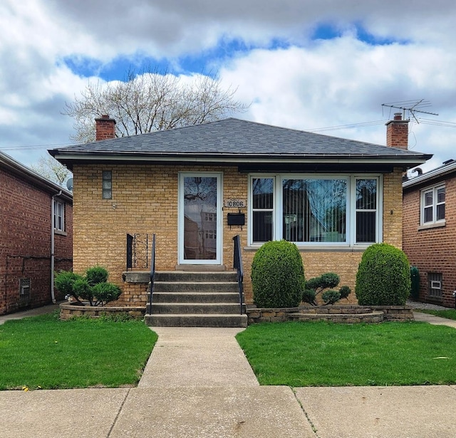 10806 S S Ave O, Chicago, IL 60617 - bungalow-style house with entry steps, brick siding, a front lawn, and a shingled roof