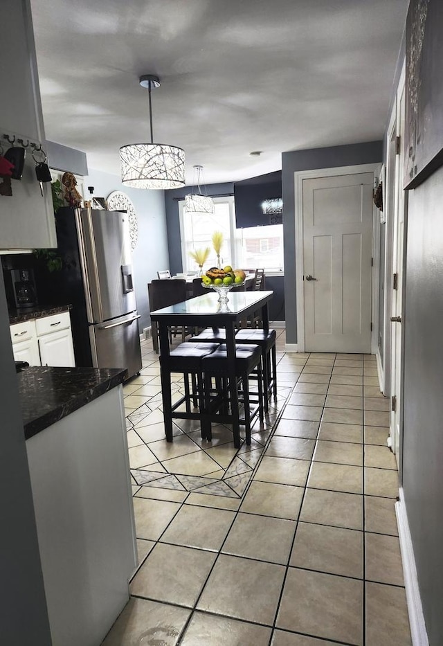 10806 S S Ave O, Chicago, IL 60617 - dining area featuring light tile patterned flooring and a chandelier