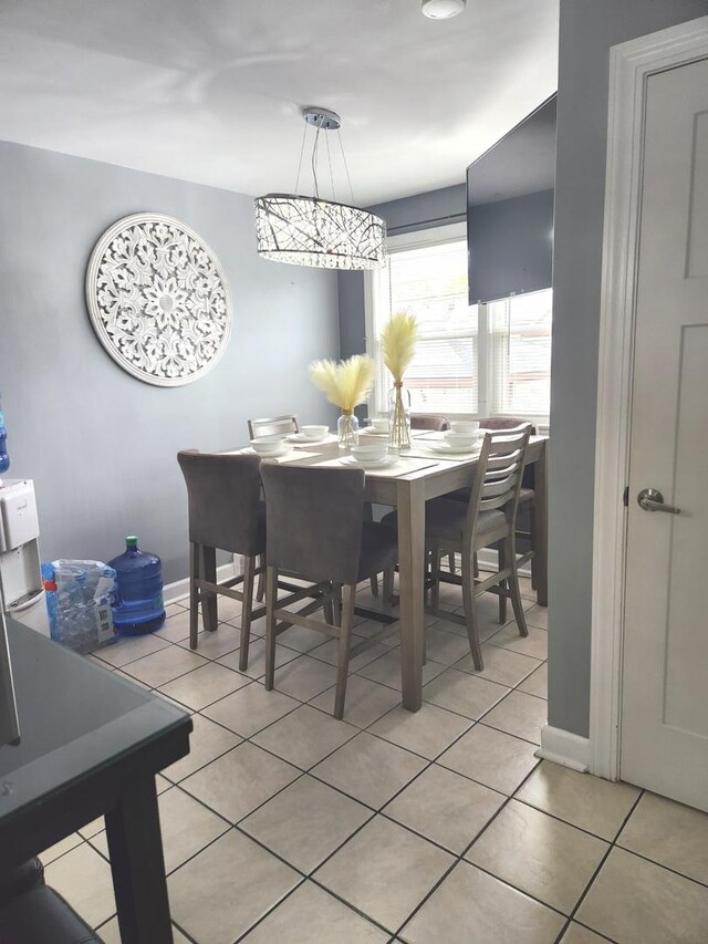 10806 S S Ave O, Chicago, IL 60617 - dining room featuring light tile patterned flooring and baseboards