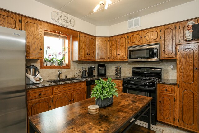 11114 Heritage Dr Unit 2D, Palos Hills, IL 60465 - kitchen featuring appliances with stainless steel finishes, brown cabinetry, and decorative backsplash