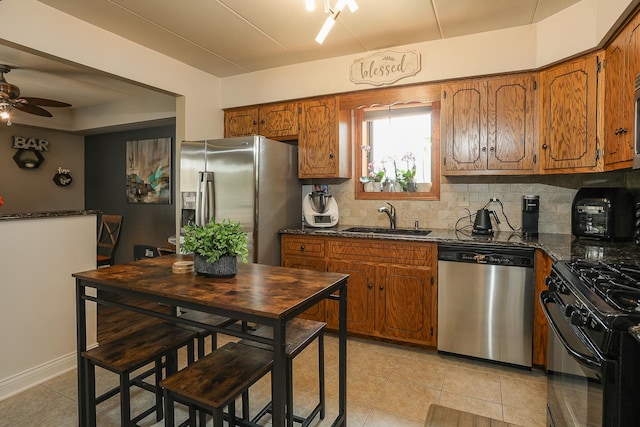 11114 Heritage Dr Unit 2D, Palos Hills, IL 60465 - kitchen featuring stainless steel appliances, brown cabinets, tasteful backsplash, a ceiling fan, and light tile patterned floors