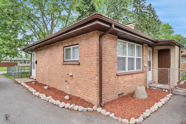 3102 Stafford Dr, Markham, IL 60428 - view of home's exterior featuring crawl space, brick siding, and a chimney
