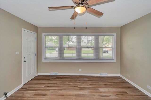 3102 Stafford Dr, Markham, IL 60428 - spare room with healthy amount of natural light, wood finished floors, and a ceiling fan