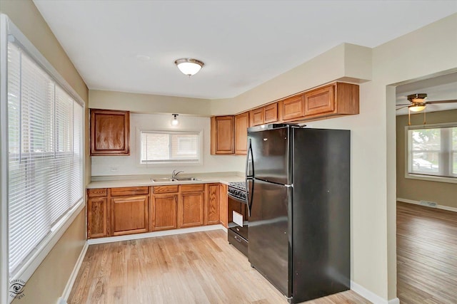 3102 Stafford Dr, Markham, IL 60428 - kitchen with black appliances, light wood-type flooring, light countertops, brown cabinets, and ceiling fan