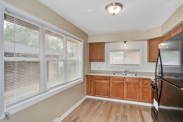 3102 Stafford Dr, Markham, IL 60428 - kitchen with freestanding refrigerator, light wood finished floors, light countertops, and brown cabinets