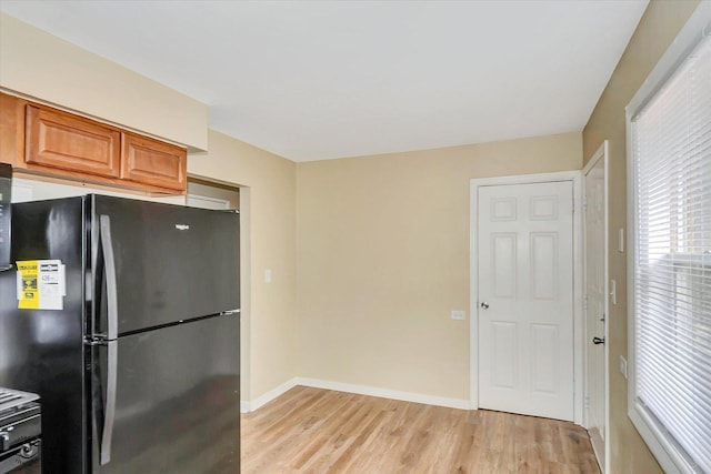 3102 Stafford Dr, Markham, IL 60428 - kitchen with freestanding refrigerator, light wood-style flooring, and brown cabinetry