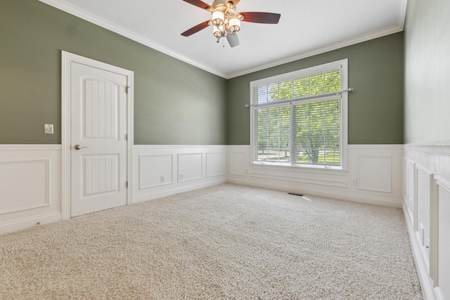 207 Quinlan Ave, Dekalb, IL 60115 - unfurnished room featuring carpet, wainscoting, ornamental molding, a ceiling fan, and a decorative wall