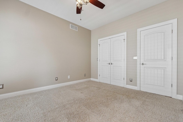 207 Quinlan Ave, Dekalb, IL 60115 - unfurnished bedroom with carpet flooring, a closet, and a ceiling fan