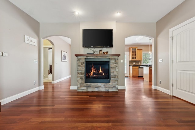 207 Quinlan Ave, Dekalb, IL 60115 - unfurnished living room with wood finished floors and a fireplace