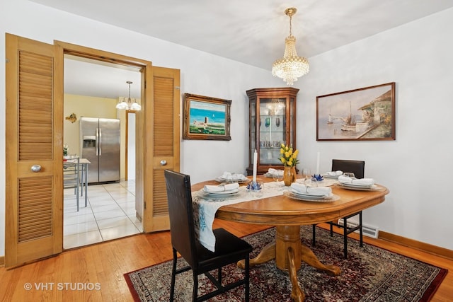 8544 W Roseview Dr, Niles, IL 60714 - dining area with a chandelier and light wood finished floors