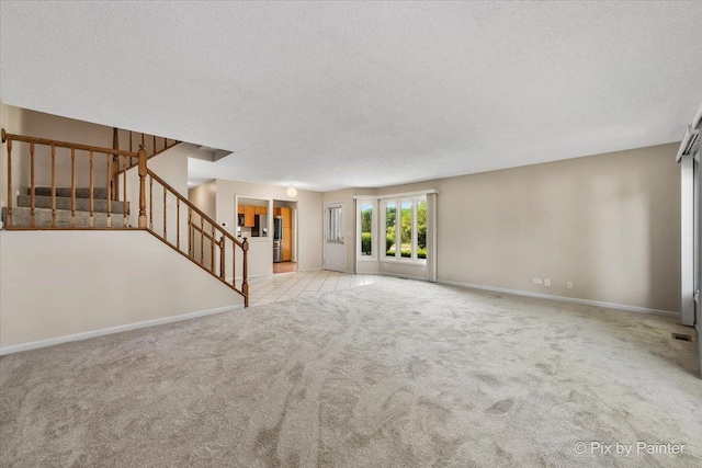 372 Goshawk Ln, Deerfield, IL 60015 - unfurnished living room featuring a textured ceiling, stairs, and carpet floors
