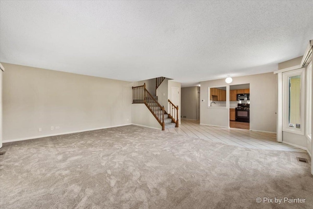 372 Goshawk Ln, Deerfield, IL 60015 - unfurnished living room featuring stairway, light carpet, and a textured ceiling