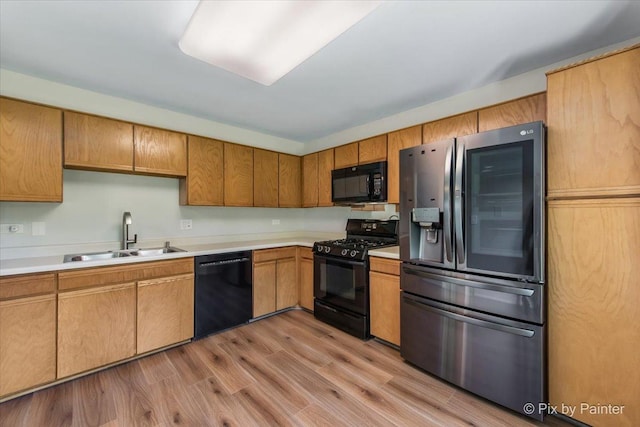372 Goshawk Ln, Deerfield, IL 60015 - kitchen with black appliances, light countertops, light wood-style flooring, and brown cabinets