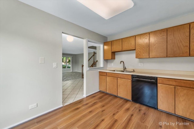 372 Goshawk Ln, Deerfield, IL 60015 - kitchen featuring black dishwasher, light countertops, light wood-style floors, and brown cabinets