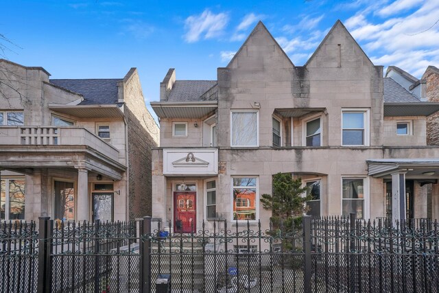 6505 S Woodlawn Ave, Chicago, IL 60637 - view of property featuring stone siding and a fenced front yard