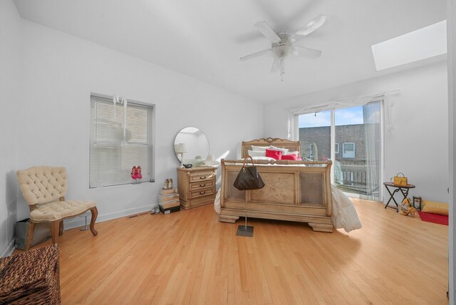 6505 S Woodlawn Ave, Chicago, IL 60637 - bedroom featuring access to exterior, light wood finished floors, a skylight, and a ceiling fan