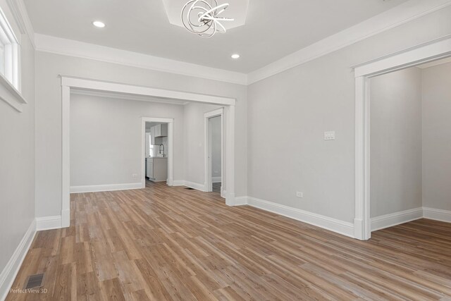 2028 S 5th Ave, Maywood, IL 60153 - empty room with a chandelier, light wood-style floors, crown molding, and recessed lighting