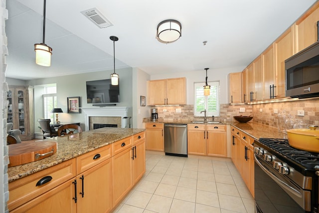 875 E 22nd St Unit 220, Lombard, IL 60148 - kitchen featuring stainless steel appliances, tasteful backsplash, light tile patterned flooring, a fireplace, and light stone counters