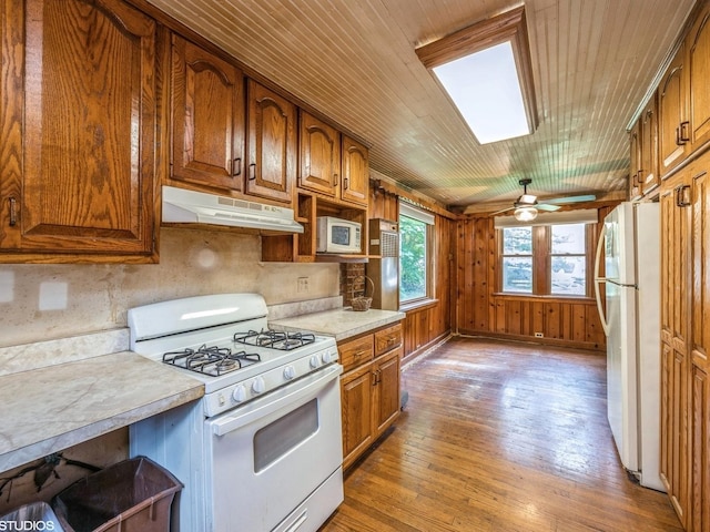 11933 S 70th Ave, Palos Heights, IL 60463 - kitchen featuring white appliances, under cabinet range hood, light wood-style floors, light countertops, and brown cabinets