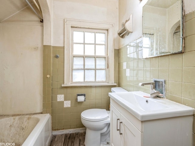 11933 S 70th Ave, Palos Heights, IL 60463 - full bath with tile walls, a tub, vanity, toilet, and wood finished floors