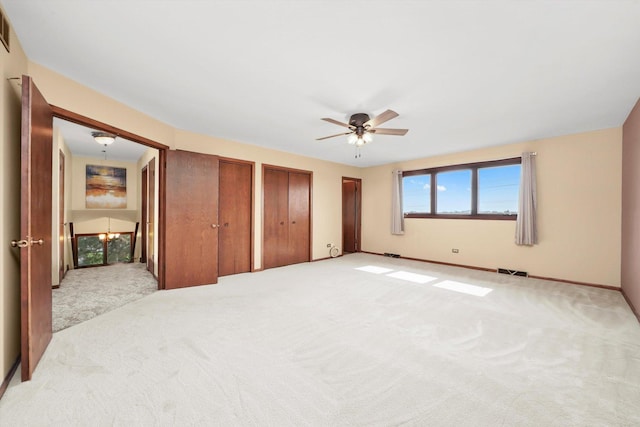 14023 S Split Rail Dr, Homer Glen, IL 60491 - unfurnished bedroom with light colored carpet, two closets, and a ceiling fan