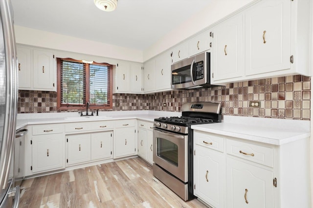 14023 S Split Rail Dr, Homer Glen, IL 60491 - kitchen with appliances with stainless steel finishes, light countertops, decorative backsplash, and white cabinetry