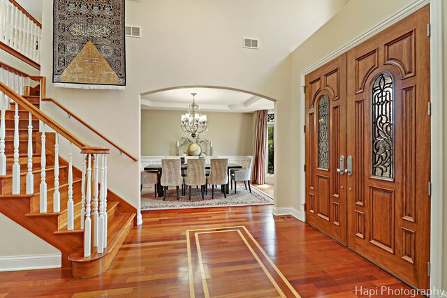 1400 Banbury Rd, Inverness, IL 60067 - foyer featuring arched walkways, wood finished floors, stairs, and a chandelier
