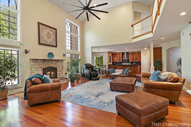1400 Banbury Rd, Inverness, IL 60067 - living area featuring a towering ceiling, wood-type flooring, a fireplace, arched walkways, and recessed lighting