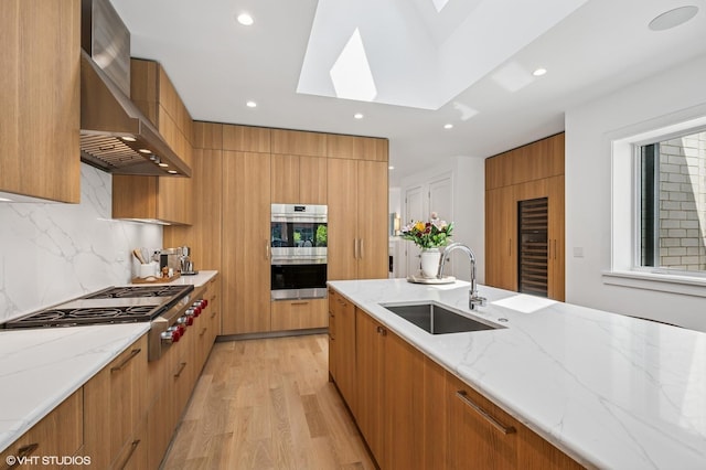 226 S Green St Unit 4N, Chicago, IL 60607 - kitchen with modern cabinets, wall chimney range hood, stainless steel appliances, and recessed lighting