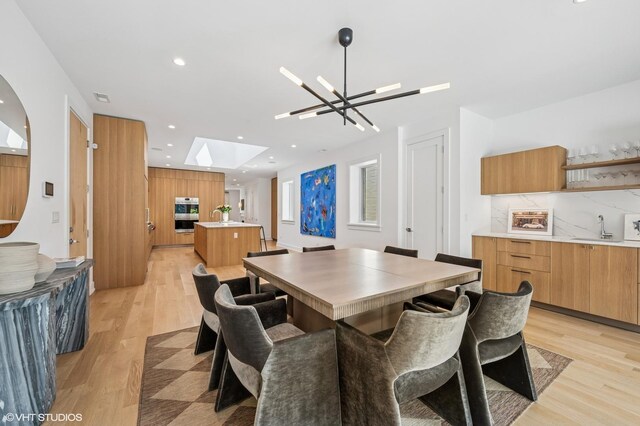 226 S Green St Unit 4N, Chicago, IL 60607 - dining area with a chandelier, light wood-style floors, recessed lighting, and a skylight