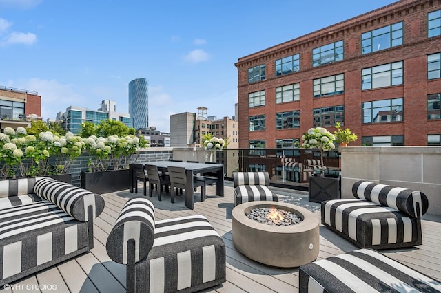 226 S Green St Unit 4N, Chicago, IL 60607 - wooden deck featuring a view of city, a fire pit, and outdoor dining area