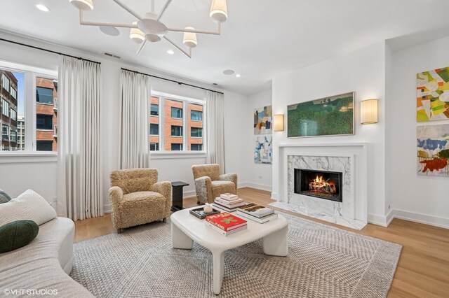 226 S Green St Unit 4N, Chicago, IL 60607 - living room featuring wood finished floors, recessed lighting, a fireplace, and a chandelier