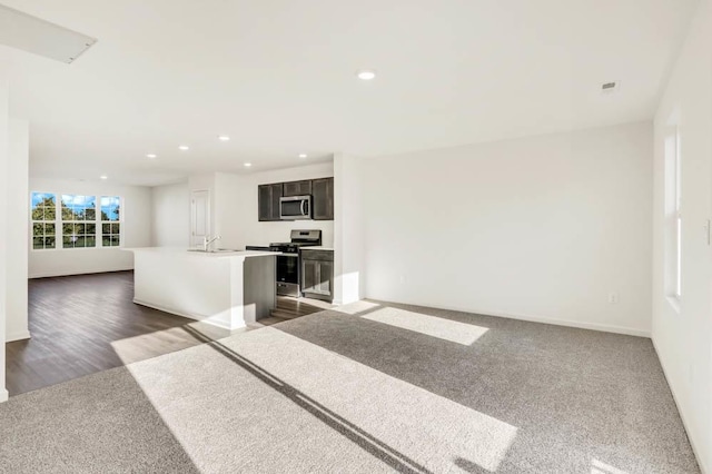 873 Briar Glen Ct, Hampshire, IL 60140 - kitchen featuring appliances with stainless steel finishes, open floor plan, a center island with sink, recessed lighting, and light countertops
